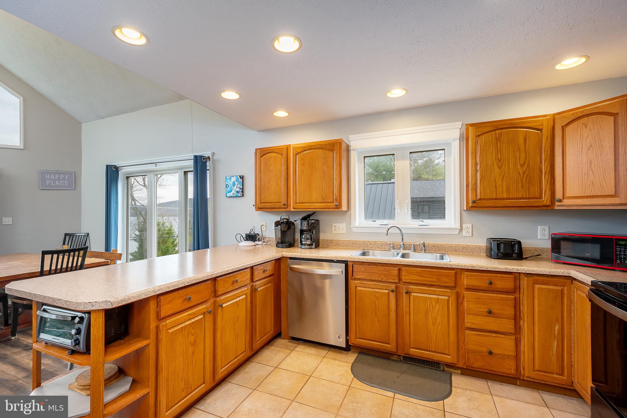 638 Glendale Road Oakland, MD 21550 - Photo 14 of 56 a large kitchen with kitchen island a sink a stove a counter space and cabinets
