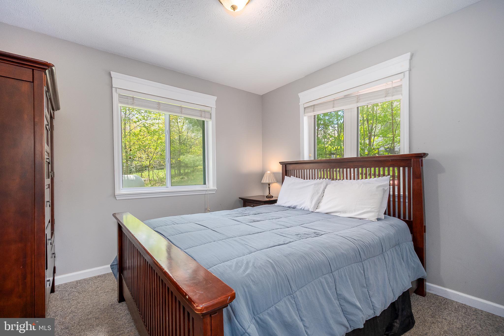 638 Glendale Road Oakland, MD 21550 - Photo 23 of 56 a bed sitting in a bedroom next to a window