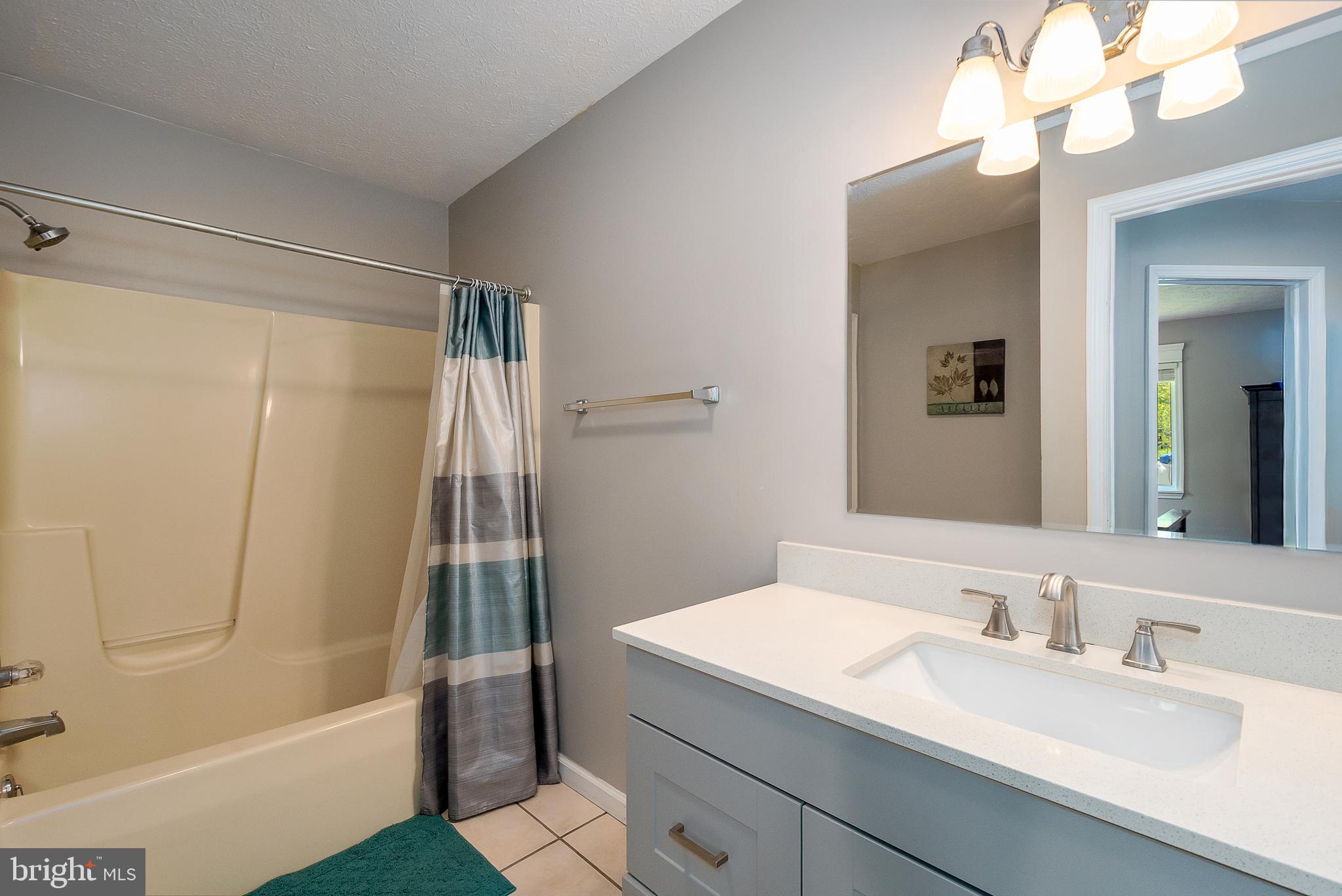 638 Glendale Road Oakland, MD 21550 - Photo 26 of 56 a bathroom with a granite countertop sink a toilet and shower