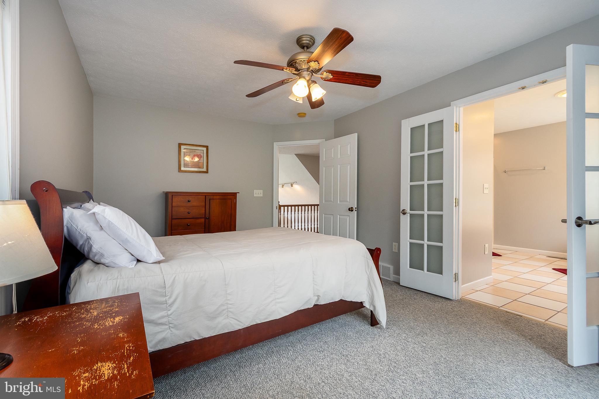 638 Glendale Road Oakland, MD 21550 - Photo 38 of 56 a bedroom with a bed and a chandelier