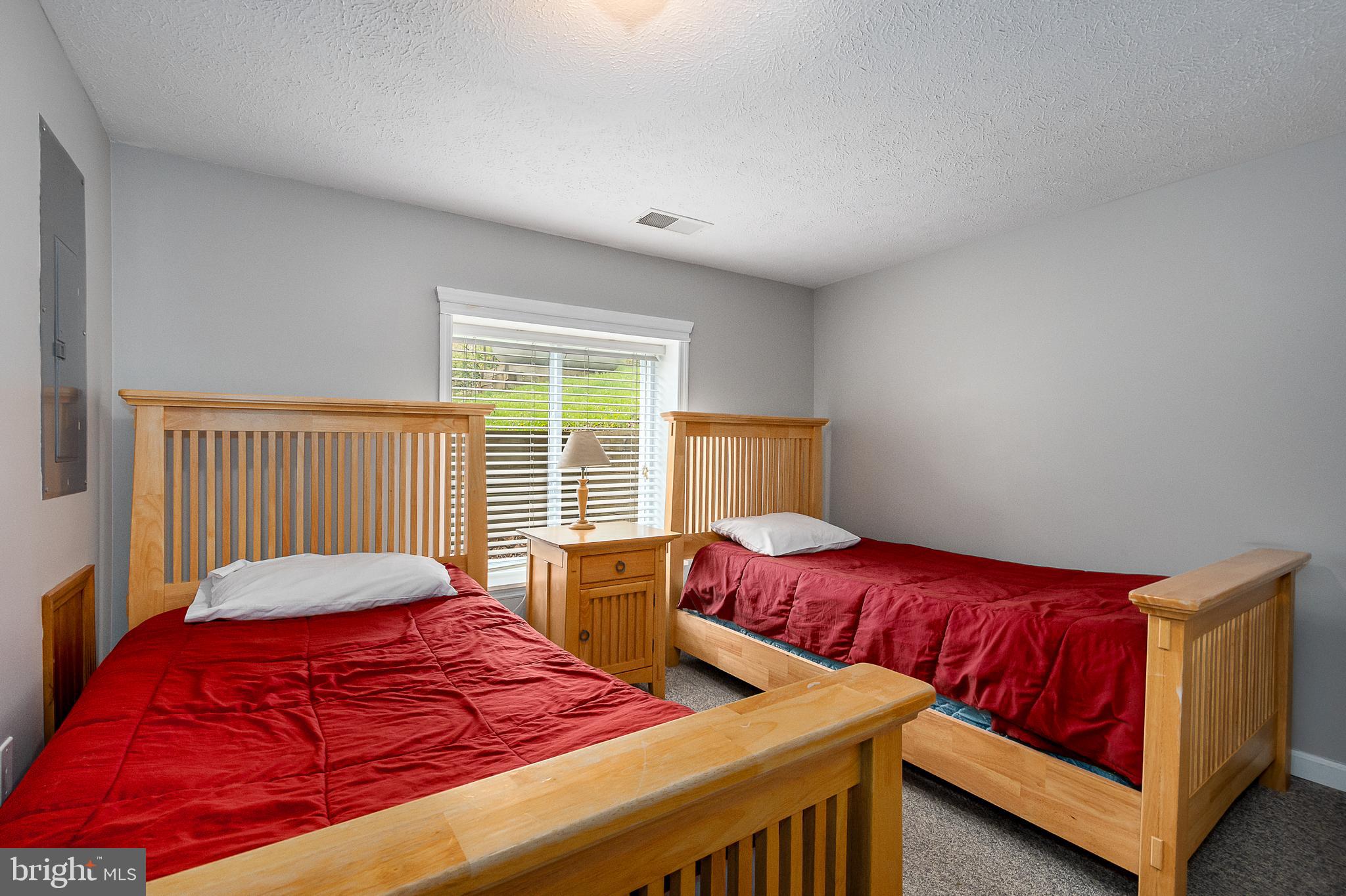638 Glendale Road Oakland, MD 21550 - Photo 52 of 56 a bedroom with two beds and a large window
