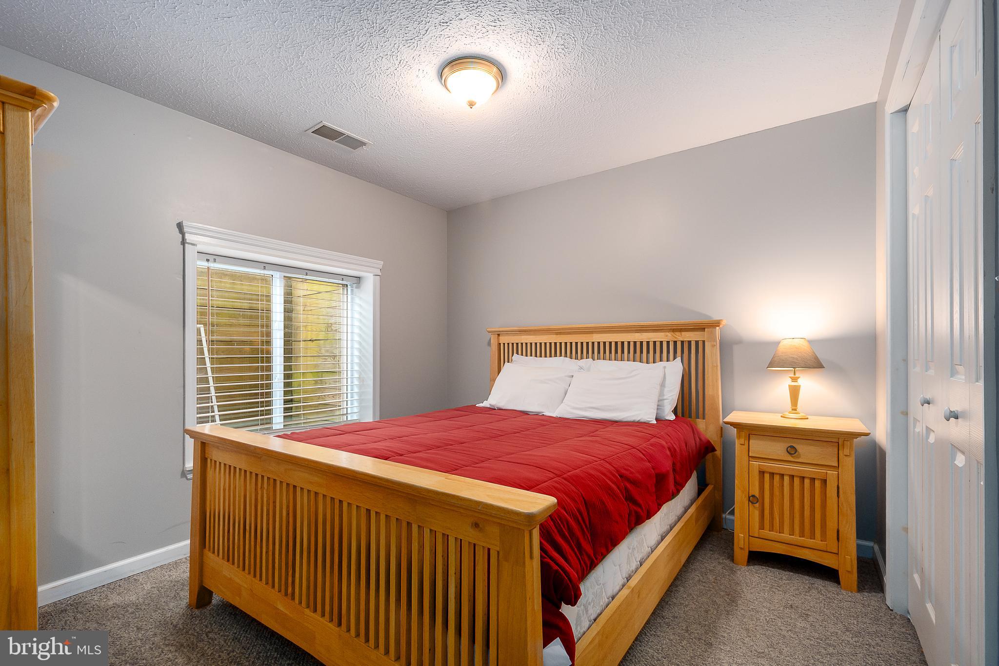 638 Glendale Road Oakland, MD 21550 - Photo 54 of 56 a bedroom with a bed and a night stand