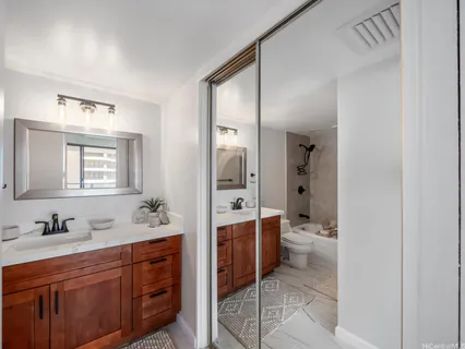 a spacious bathroom with a double vanity sink a mirror and a bathtub