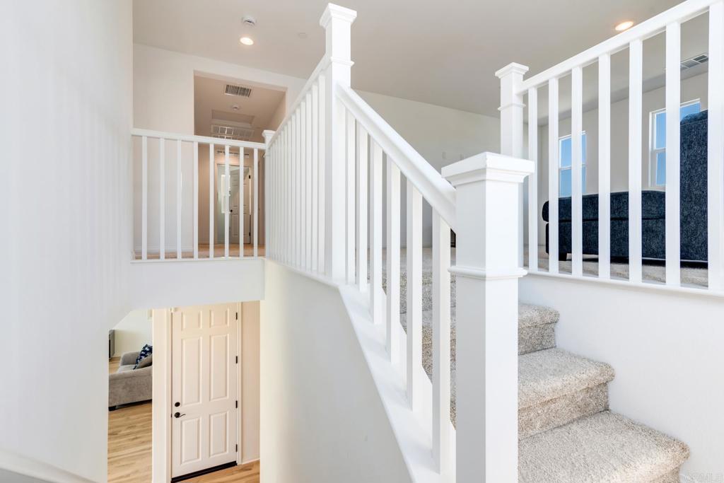 30343 Singer Lane Menifee, CA 92584 - Photo 11 of 24 a view of staircase with lots of frames on wall and a window