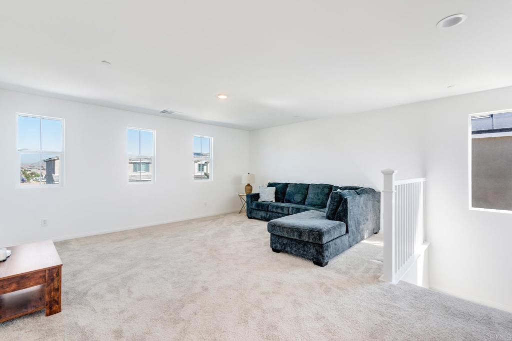 30343 Singer Lane Menifee, CA 92584 - Photo 12 of 24 a living room with furniture and a couch