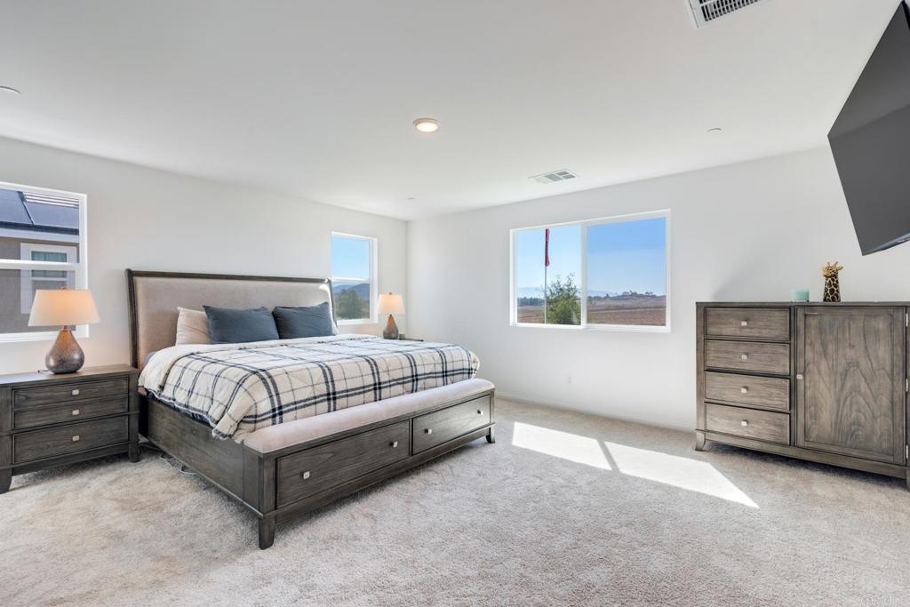 30343 Singer Lane Menifee, CA 92584 - Photo 14 of 24 a bedroom with a bed and a dresser