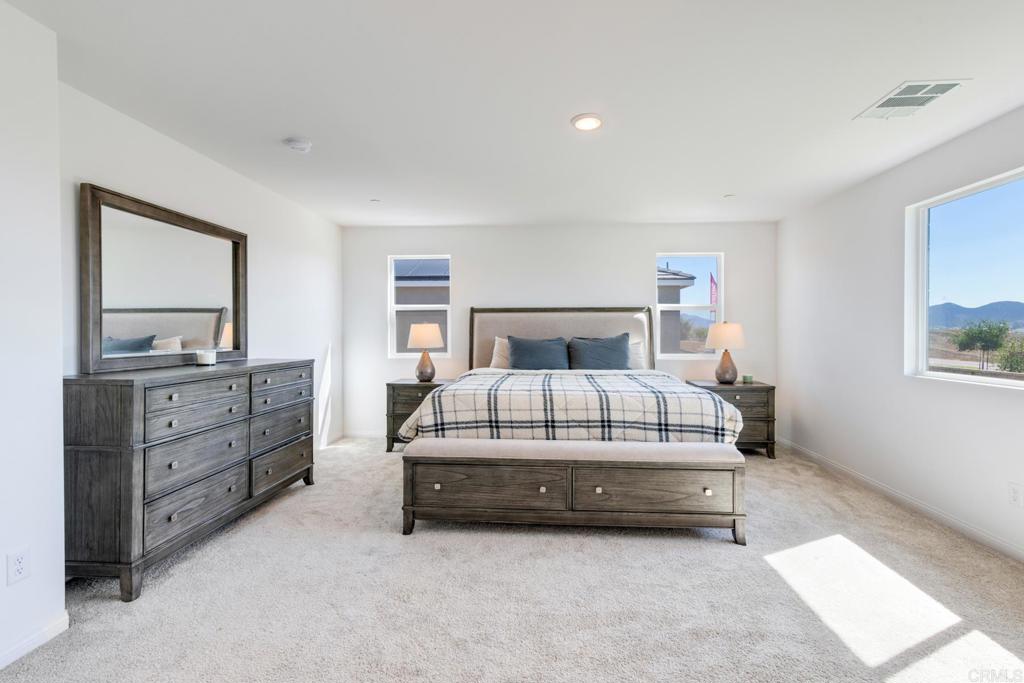 30343 Singer Lane Menifee, CA 92584 - Photo 16 of 24 a bedroom with a bed and a dresser in it