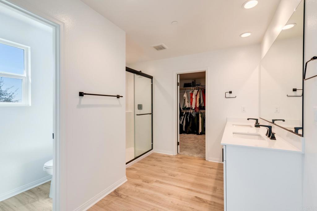 30343 Singer Lane Menifee, CA 92584 - Photo 17 of 24 a bathroom with a sink and a mirror