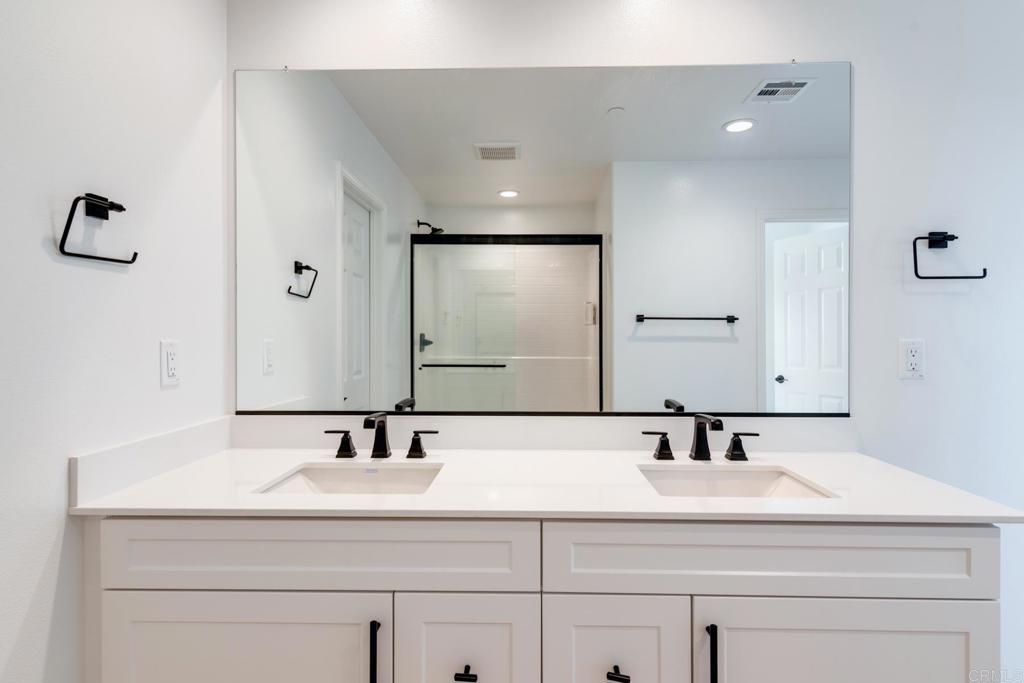30343 Singer Lane Menifee, CA 92584 - Photo 18 of 24 a bathroom with a sink and a mirror