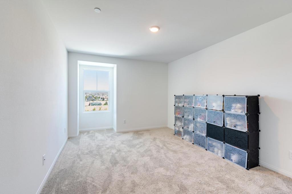 30343 Singer Lane Menifee, CA 92584 - Photo 20 of 24 an empty room with a cabinet and mirrors