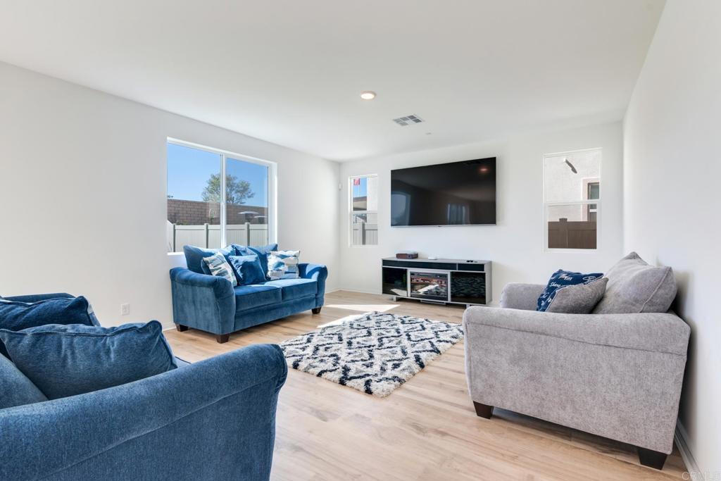 30343 Singer Lane Menifee, CA 92584 - Photo 5 of 24 a living room with furniture and a flat screen tv