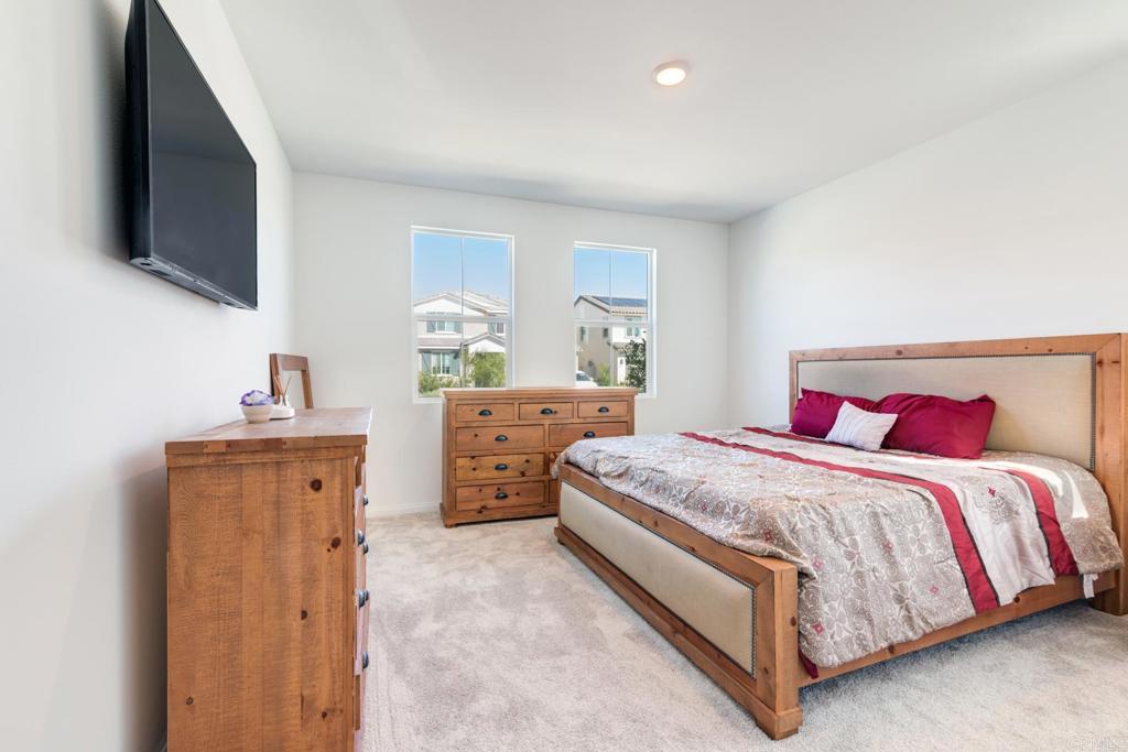 30343 Singer Lane Menifee, CA 92584 - Photo 8 of 24 a bedroom with a bed and a flat screen tv