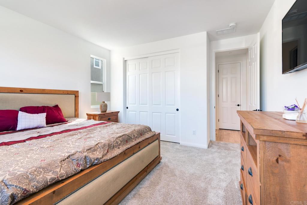 30343 Singer Lane Menifee, CA 92584 - Photo 9 of 24 a bedroom with a bed and a flat screen tv