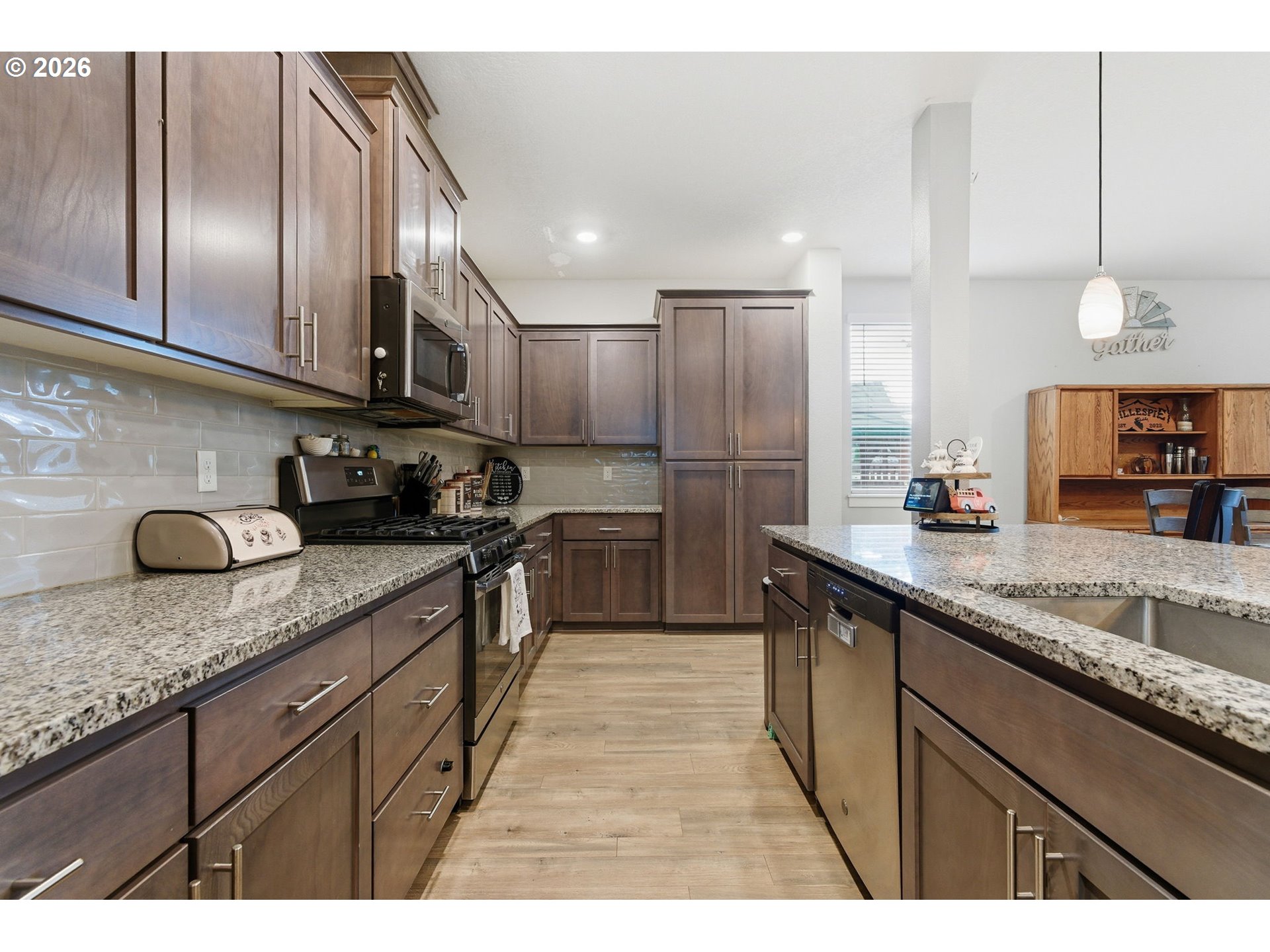 476 Southwest 15th Avenue Canby, OR 97013 - Photo 12 of 41 a kitchen with stainless steel appliances granite countertop a sink a stove and a refrigerator