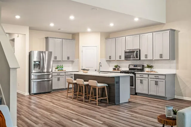 a living room with furniture and view of kitchen