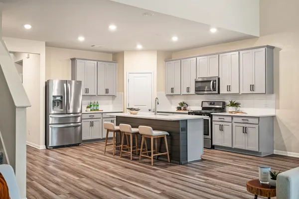 a living room with furniture and kitchen view