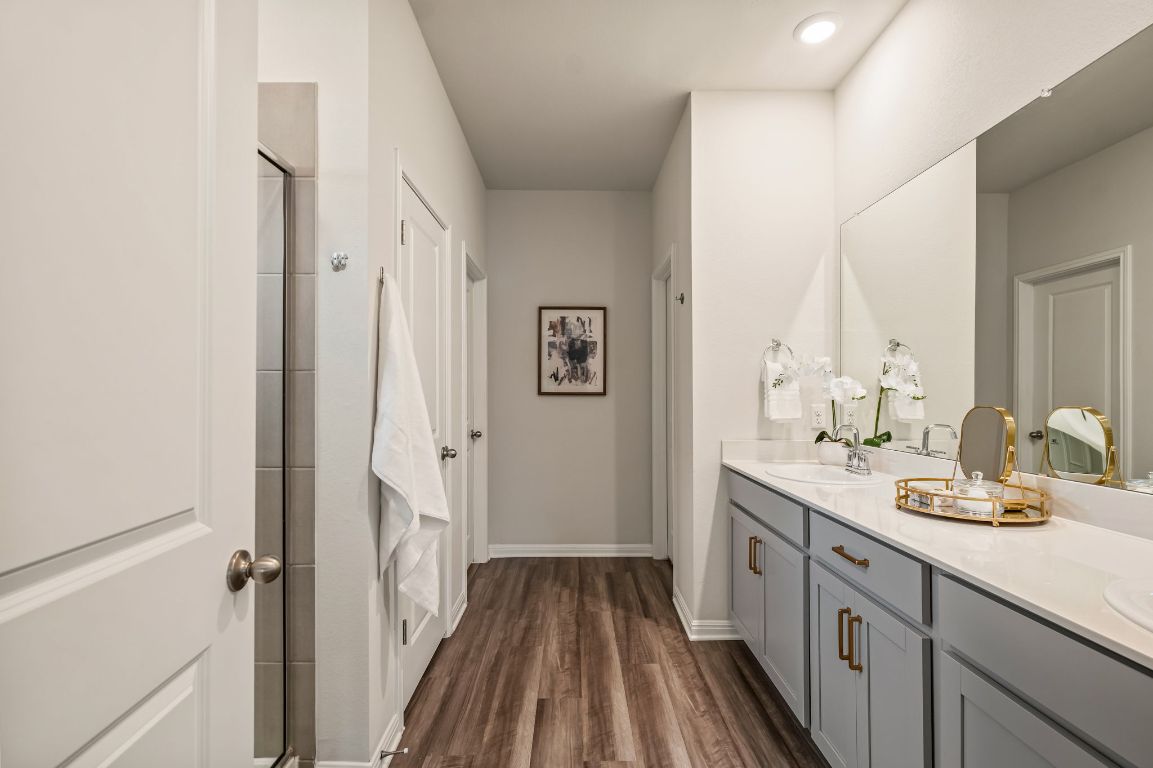1509 Deering Run Leander, TX 78641 - Photo 21 of 37 a spacious bathroom with a double vanity sink and a mirror