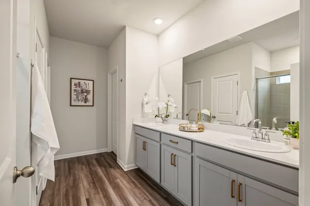 a spacious bathroom with a double vanity sink and a mirror