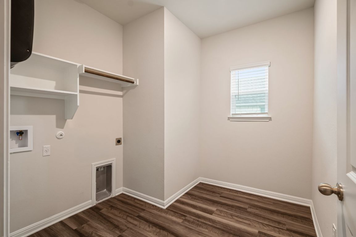 1509 Deering Run Leander, TX 78641 - Photo 28 of 37 a view of an empty room with wooden floor and a window