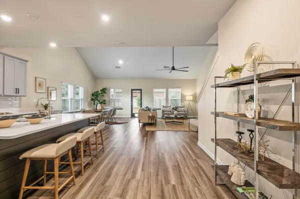 a living room with furniture potted plant and a window