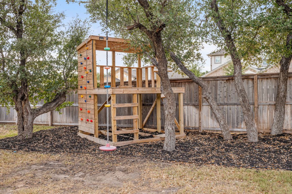 1509 Deering Run Leander, TX 78641 - Photo 36 of 37 a view of a house with a yard and large trees