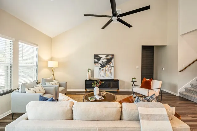 a living room with furniture and a wooden floor