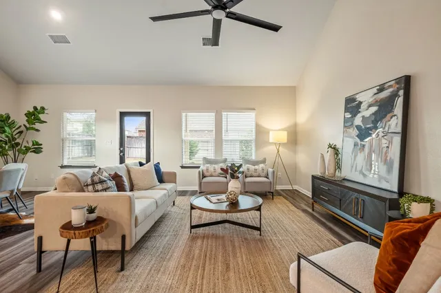 a living room with furniture and a wooden floor