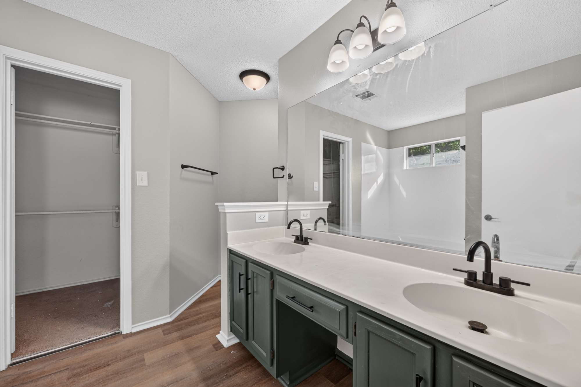 904 Nelson Ranch Road Cedar Park, TX 78613 - Photo 12 of 21 Double vanities with matte black fixtures anchor this updated space featuring wood-look flooring.