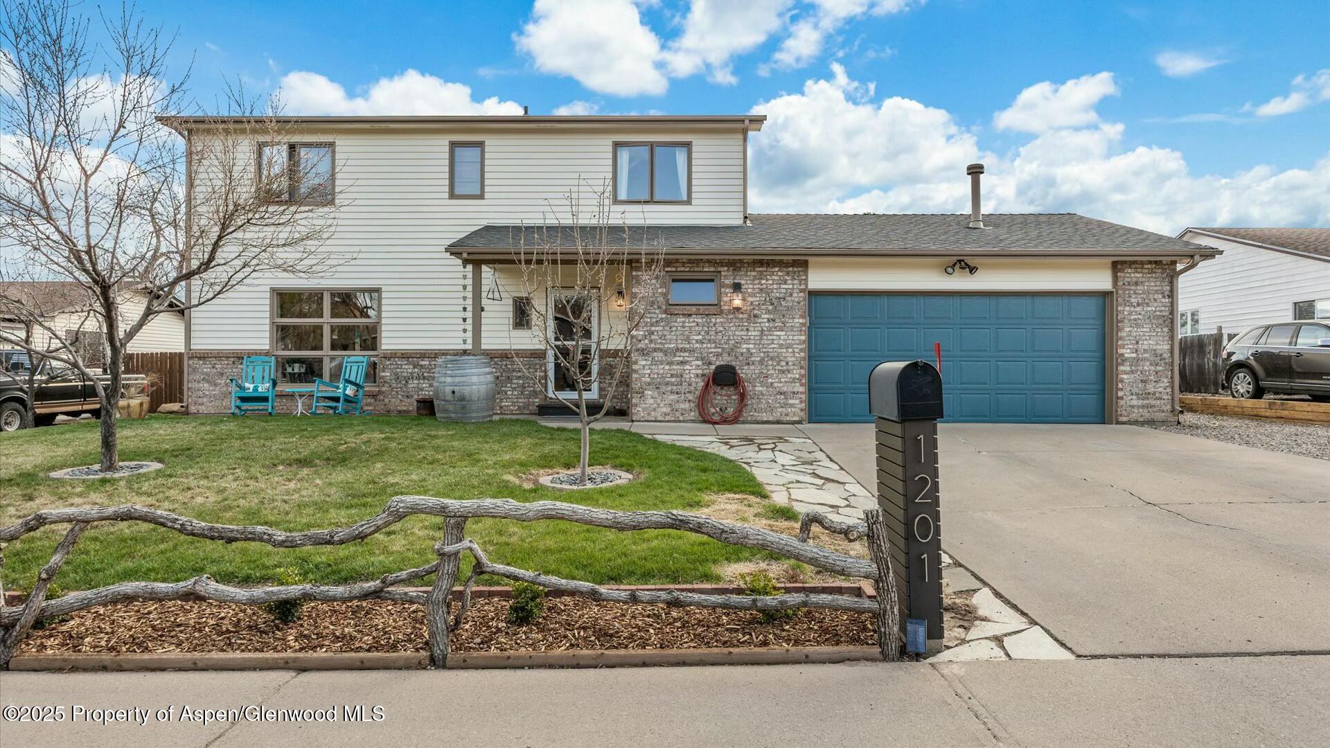 1201 Fir Avenue Rifle, CO 81650 - Photo 1 of 25 a front view of a house with garden