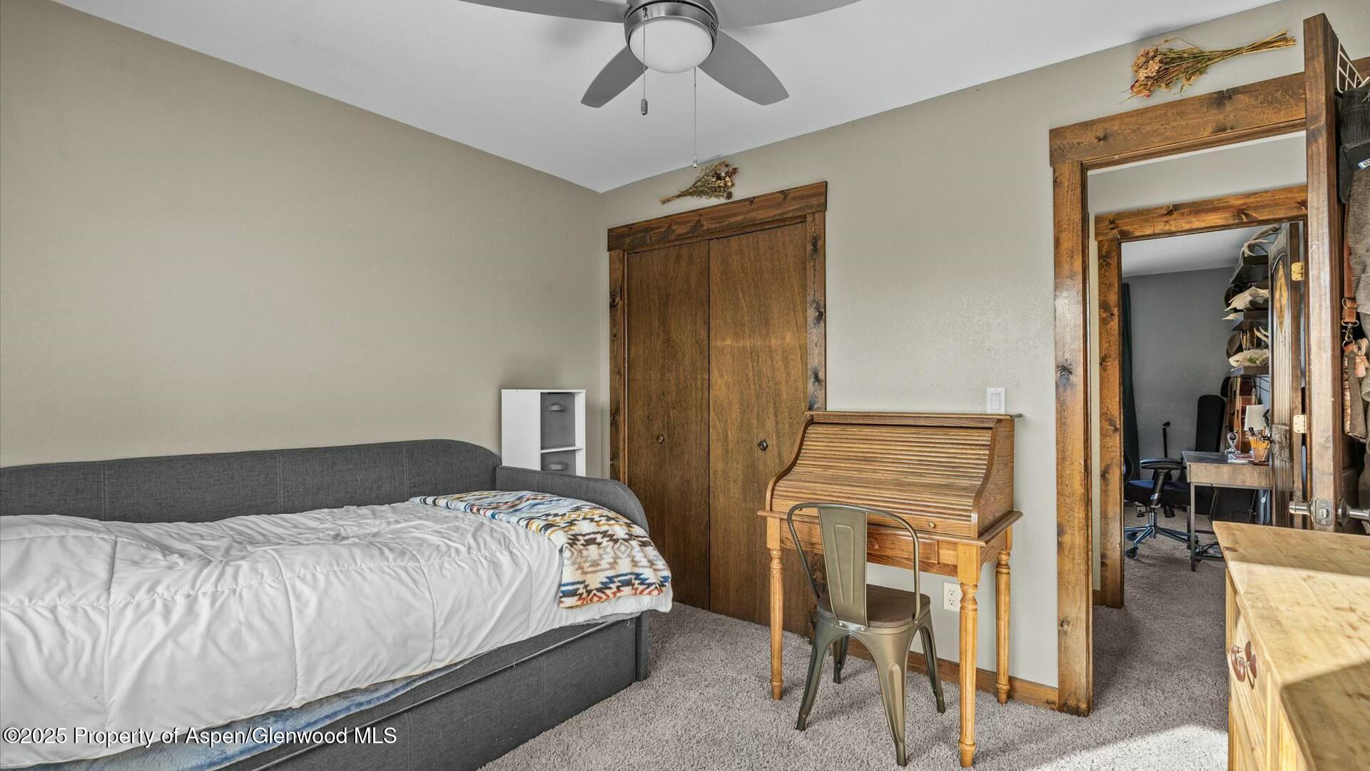 1201 Fir Avenue Rifle, CO 81650 - Photo 18 of 25 a bedroom with a bed and a chandelier
