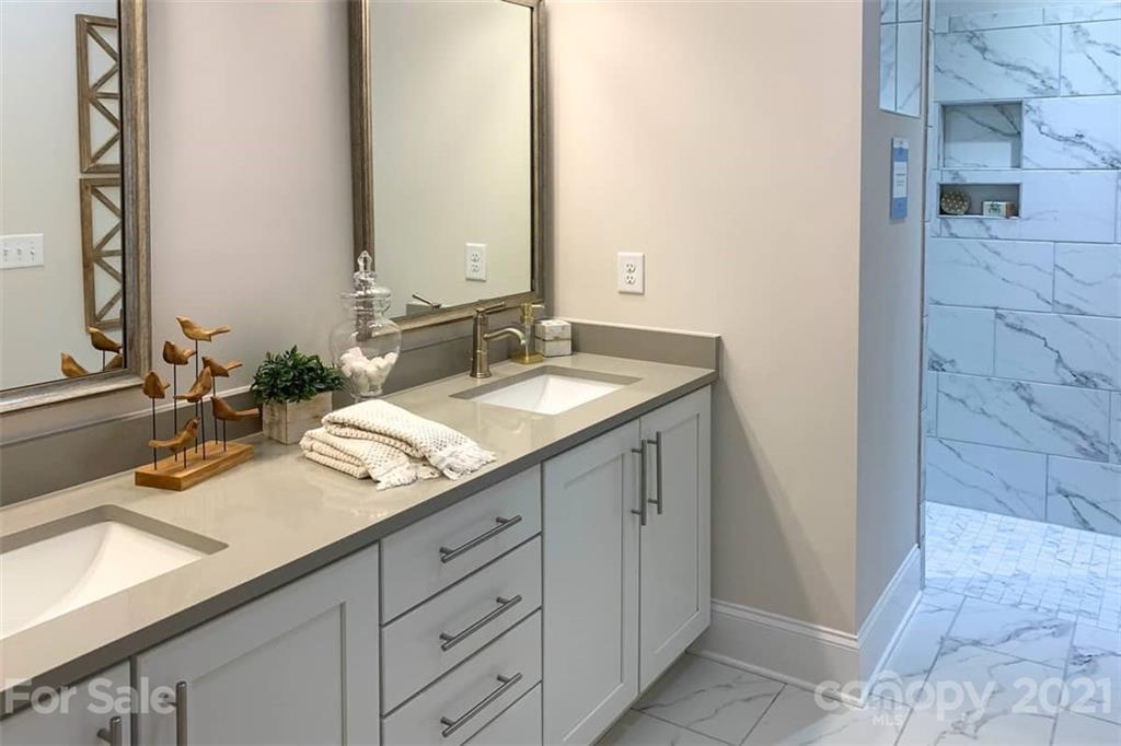 2023 New Style Way, Unit 24 Tega Cay, SC 29708 - Photo 14 of 18 a bathroom with a sink and a mirror