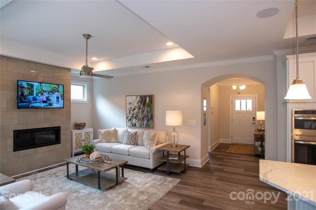 2023 New Style Way, Unit 24 Tega Cay, SC 29708 - Photo 3 of 18 a living room with furniture a fireplace and a chandelier