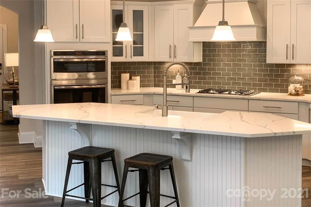 2023 New Style Way, Unit 24 Tega Cay, SC 29708 - Photo 9 of 18 a kitchen with a sink a microwave cabinets and appliances