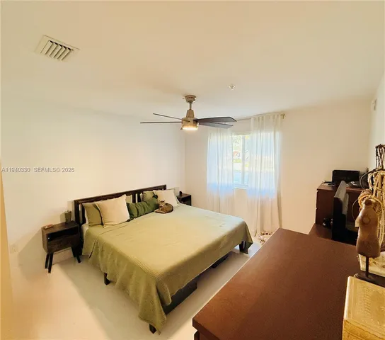 a bedroom with a bed and dresser