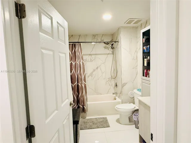 a bathroom with a shower toilet and a shower