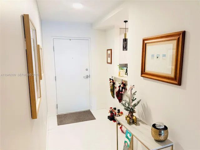 a picture of a hallway with a flower pot and a bookshelf