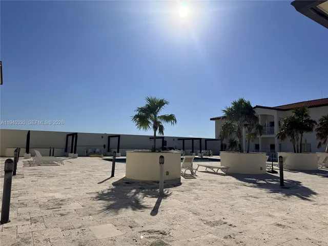 a swimming pool with outdoor seating and yard