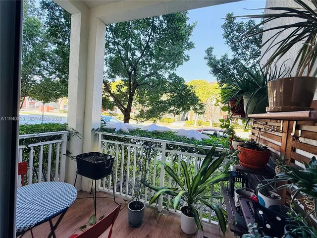 a view of a chair and tables in the balcony
