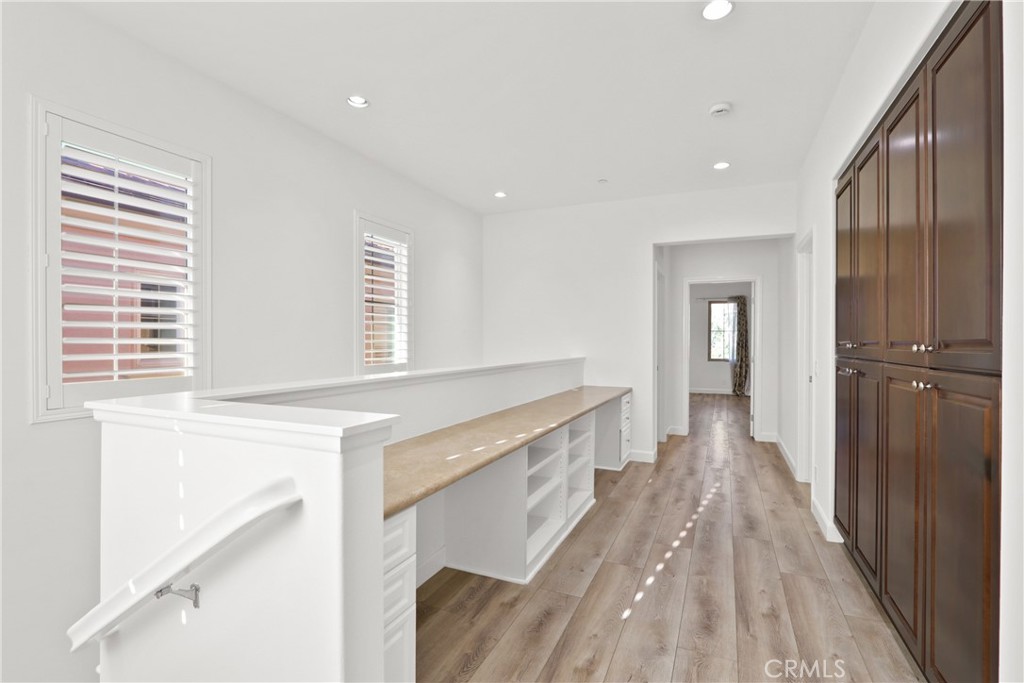 123 Windham Irvine, CA 92620 - Photo 11 of 20 a hallway view with wooden floor and staircase