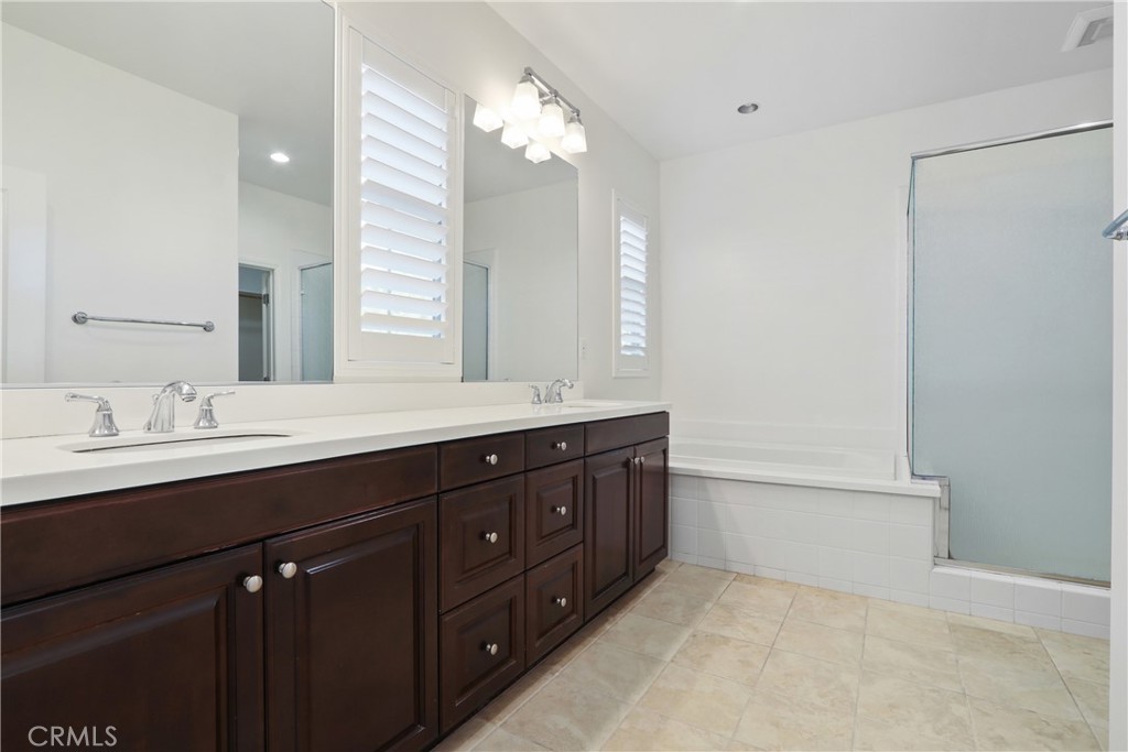 123 Windham Irvine, CA 92620 - Photo 14 of 20 a bathroom with a double vanity sink and a mirror