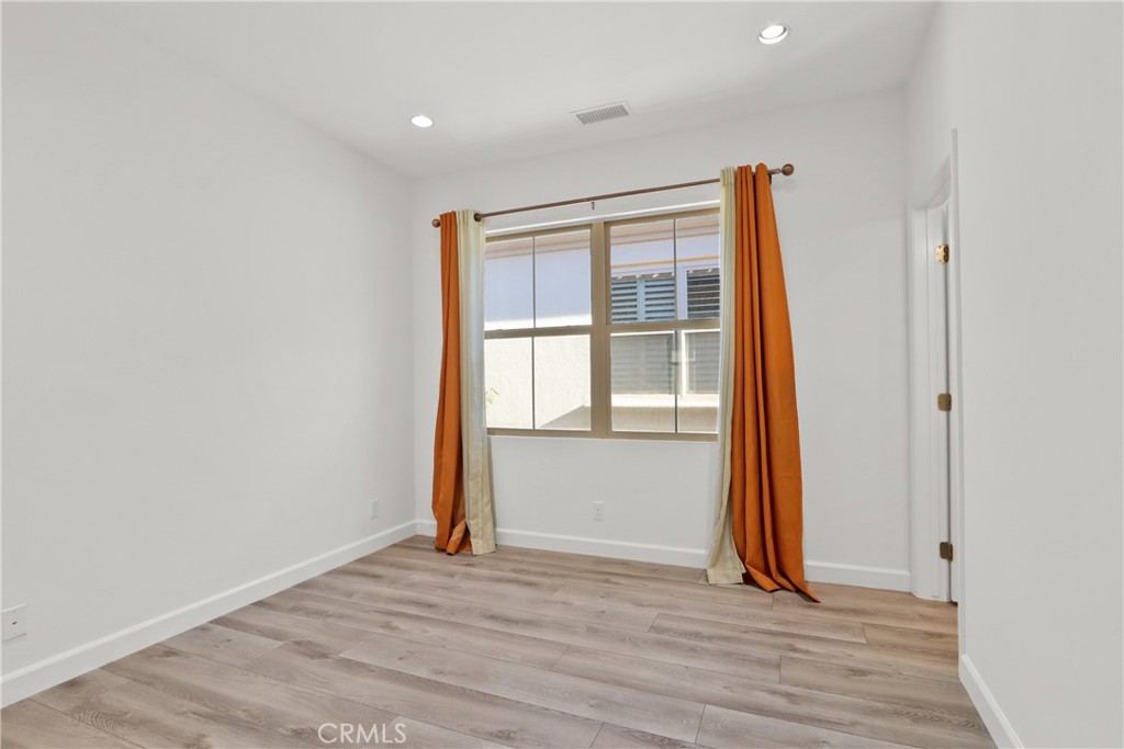 123 Windham Irvine, CA 92620 - Photo 15 of 20 a view of an empty room with wooden floor and a window