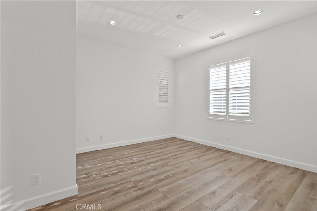 123 Windham Irvine, CA 92620 - Photo 17 of 20 an empty room with wooden floor and windows