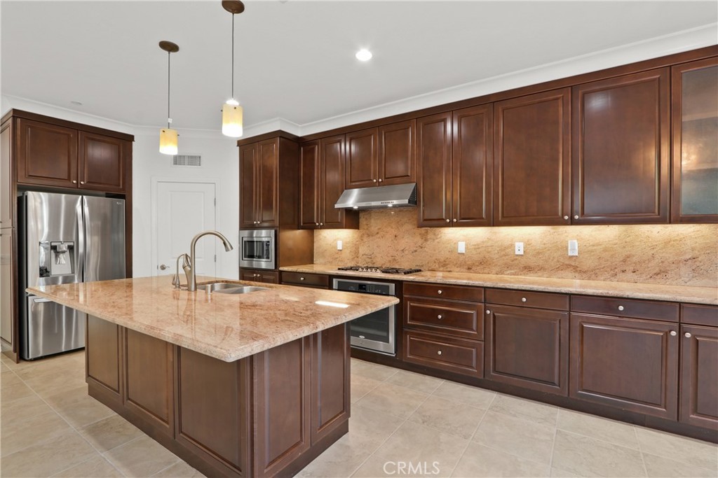 123 Windham Irvine, CA 92620 - Photo 2 of 20 a kitchen with kitchen island granite countertop stainless steel appliances a sink stove and refrigerator