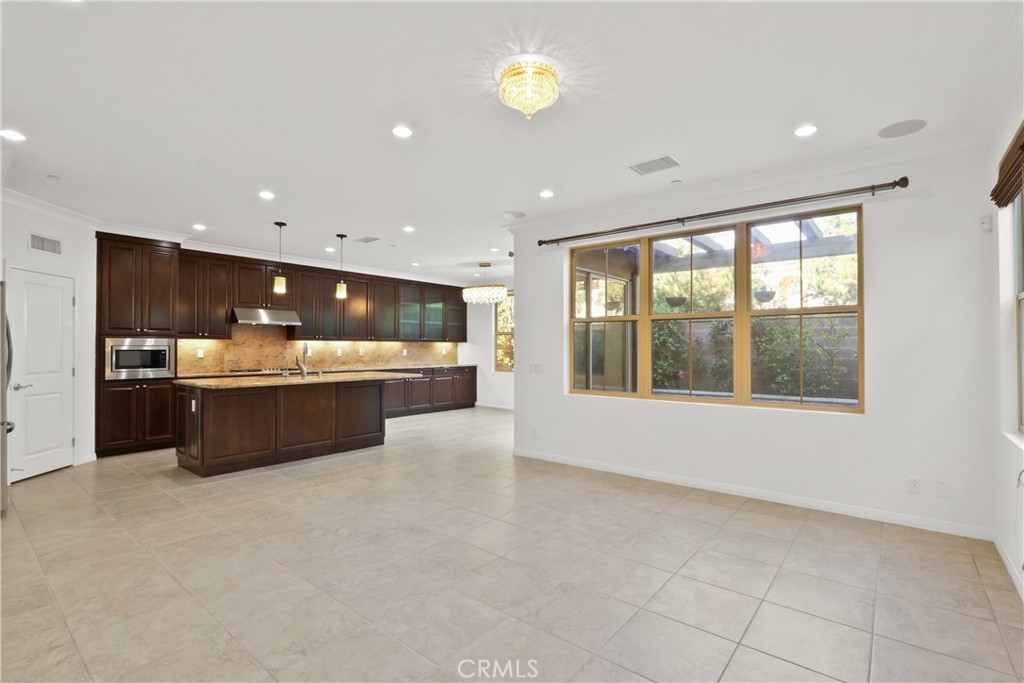 123 Windham Irvine, CA 92620 - Photo 5 of 20 a large room with a large window and a fireplace