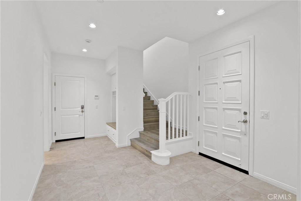 123 Windham Irvine, CA 92620 - Photo 6 of 20 an empty room with a area and white doors