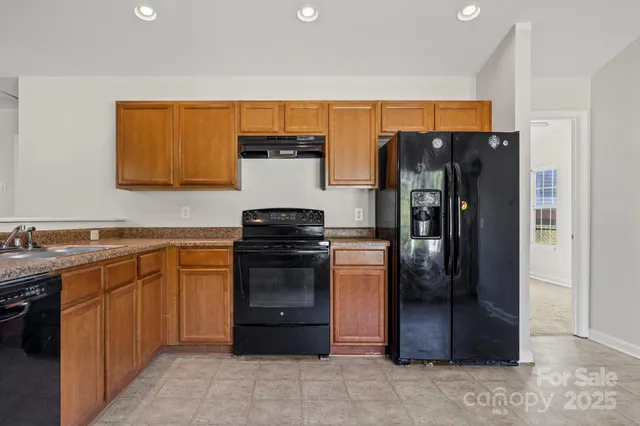 a kitchen with stainless steel appliances a refrigerator and a sink