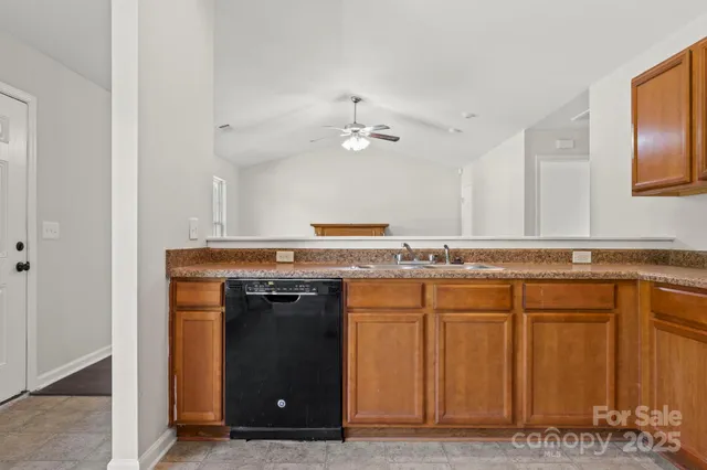 a view of a kitchen with a sink and a stove top oven