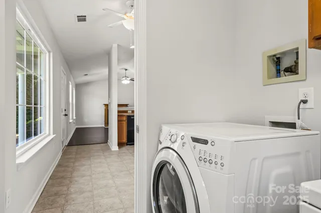 a view of washer and dryer with kitchen in the background