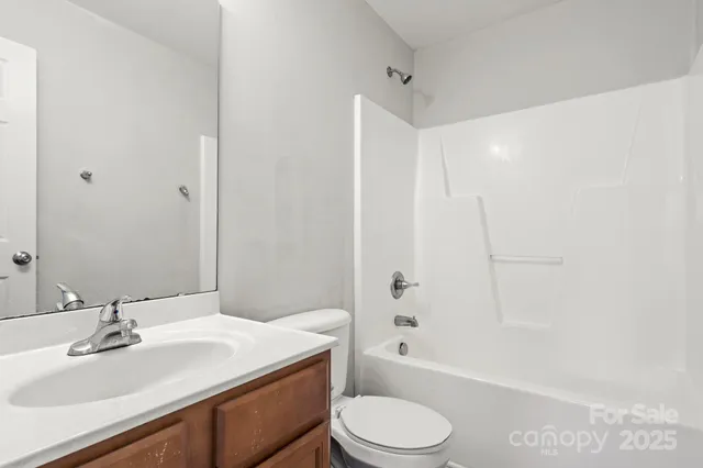 a bathroom with a sink toilet vanity and shower