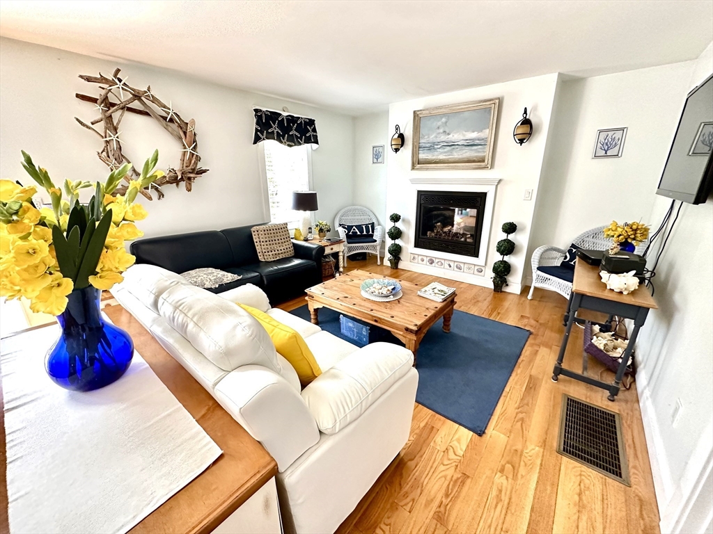 1467 State Road Plymouth, MA 02360 - Photo 4 of 31 a living room with furniture fireplace and wooden floor